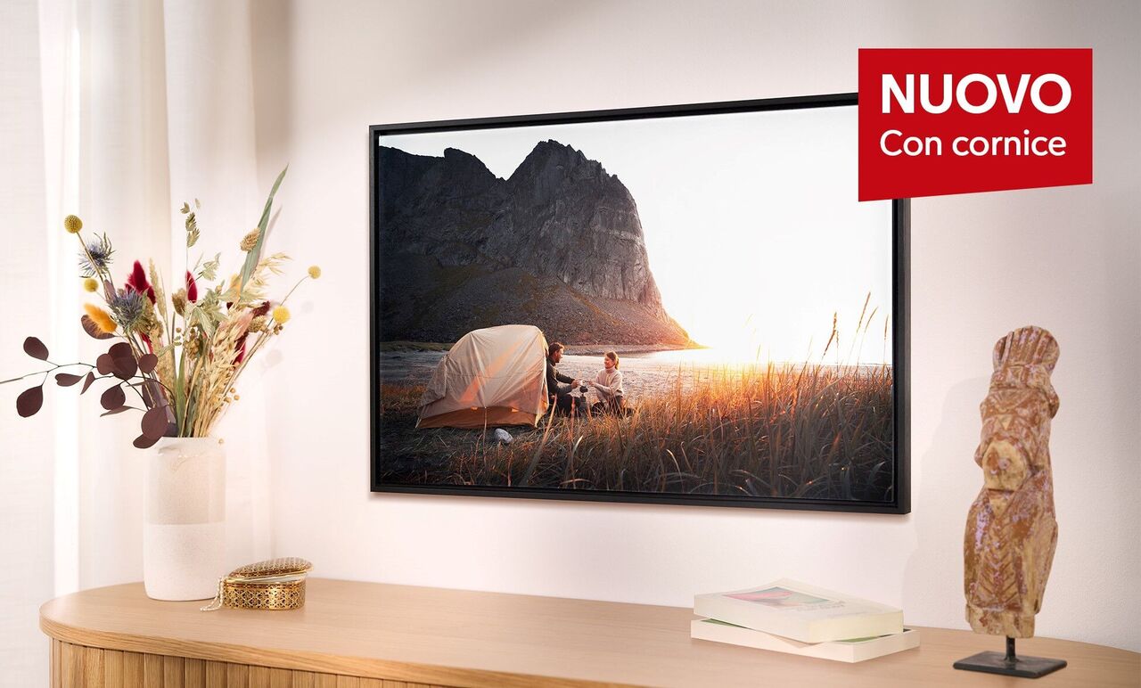 Un quadro murale con una tenda nella natura al tramonto, circondato da erba e fiori, che suscita ricordi positivi.